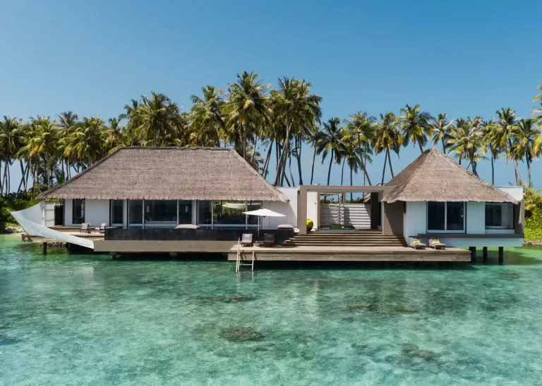 Cheval Blanc Randheli one-bedroom Garden Water Villa with pitched roof, glass walls and deck standing over a clear lagoon, Noonu Atoll, Maldives