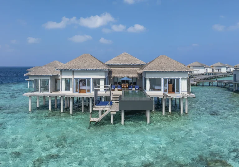 Two-bedroom overwater retreat with a large deck, private pool and steps into clear lagoon water at The Halcyon Private Isles, Maldives