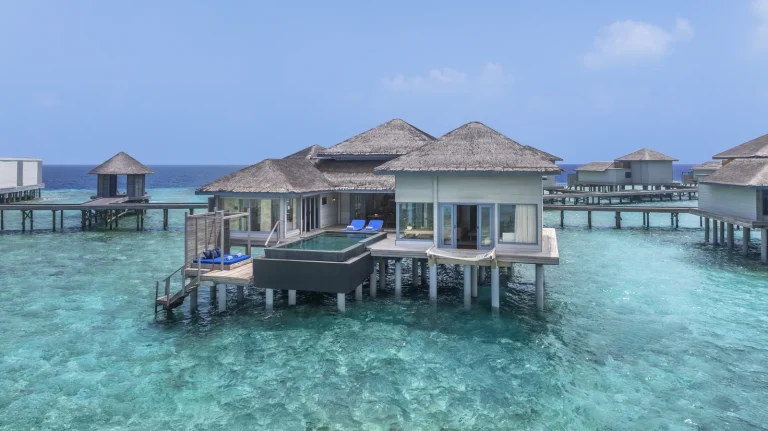 Overwater pool villa with a large deck and private pool standing over clear reef water at The Halcyon Private Isles, Gaafu Alifu Atoll, Maldives