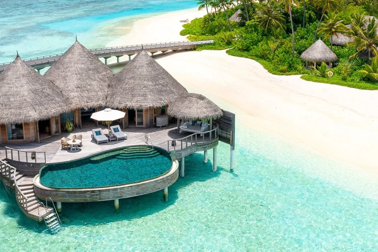 Thatched Ocean House with a round infinity pool and timber steps down to the lagoon at The Nautilus Maldives, Baa Atoll
