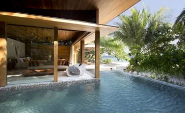 Bedroom opening onto a private pool and tropical garden in a beach villa, Coco Privé Kuda Hithi, Maldives
