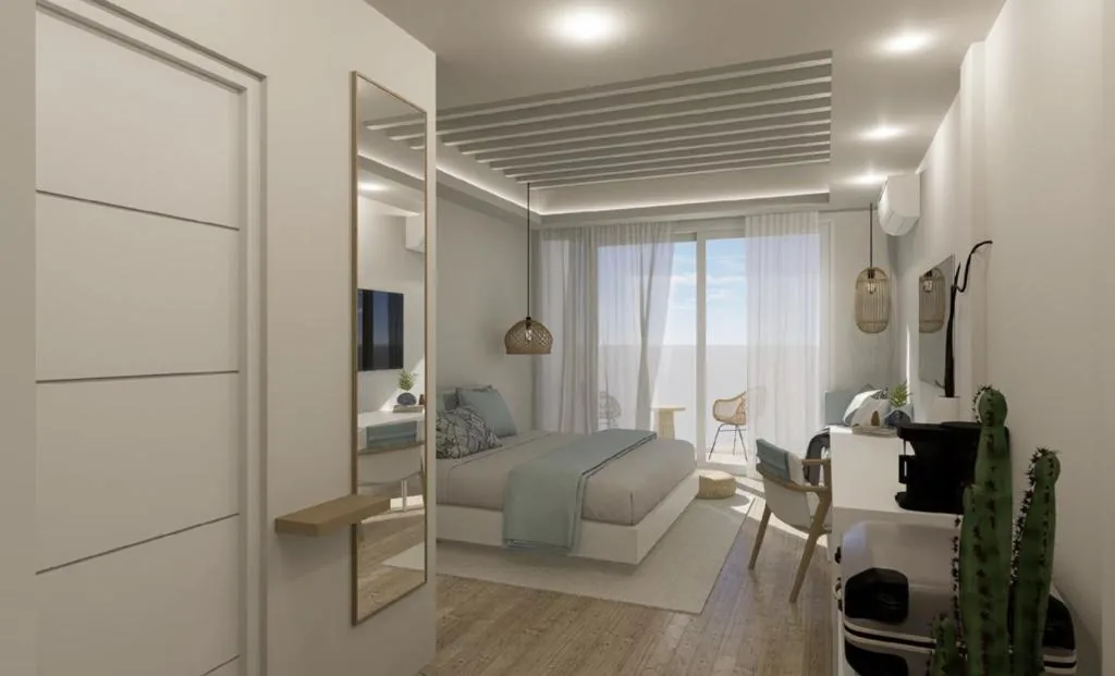Bedroom with a bed and a desk with a mirror at Dimora Blu Maldives, Dharavandhoo, Maldives