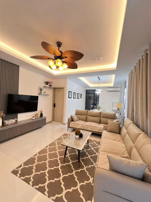 Living room with a couch and a tv at Foavahi Shark View Inn, Fuvahmulah, Maldives