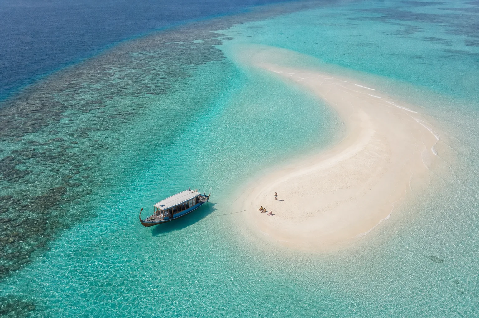Fulhadhoo excursion boat beside a sandbank in Baa Atoll, Maldives