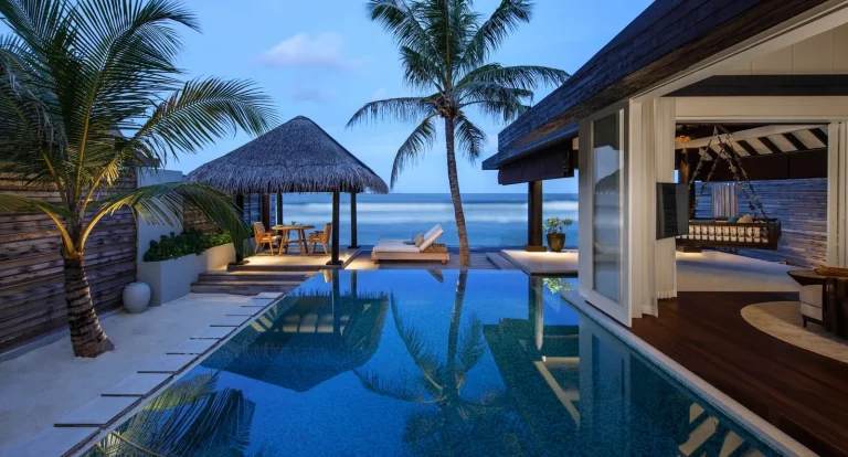 Ocean House at Naladhu Private Island with a long private pool, deck and thatched pavilion facing the lagoon, South Malé Atoll