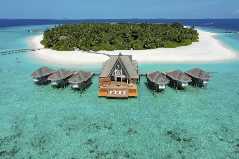 Aerial view of Anantara Kihavah island, its beach and overwater spa in Baa Atoll, Maldives