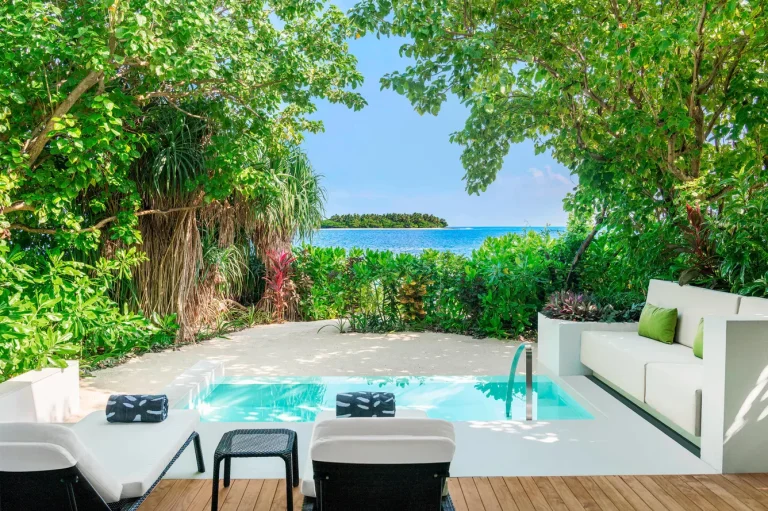 Private plunge pool, white daybed and loungers on the deck of a Beach Villa with Pool facing the beach at The Westin Maldives Miriandhoo Resort, Baa Atoll