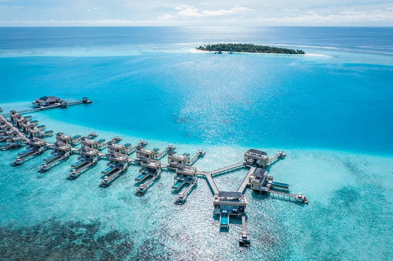 Aerial view of the InOcean pool villas at Angsana Velavaru standing in a lagoon away from the main island, Dhaalu Atoll, Maldives