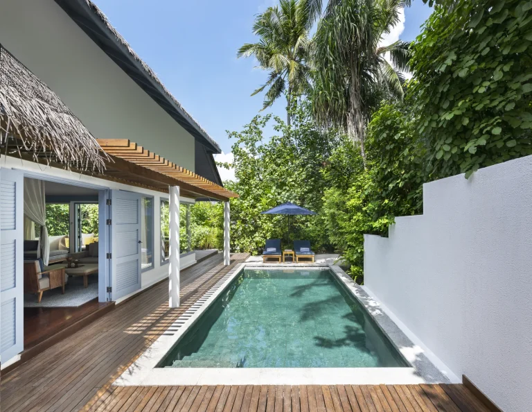 Private pool and deck of a Beach Pool Villa overlooking the sand and lagoon at The Halcyon Private Isles, Gaafu Alifu Atoll, Maldives