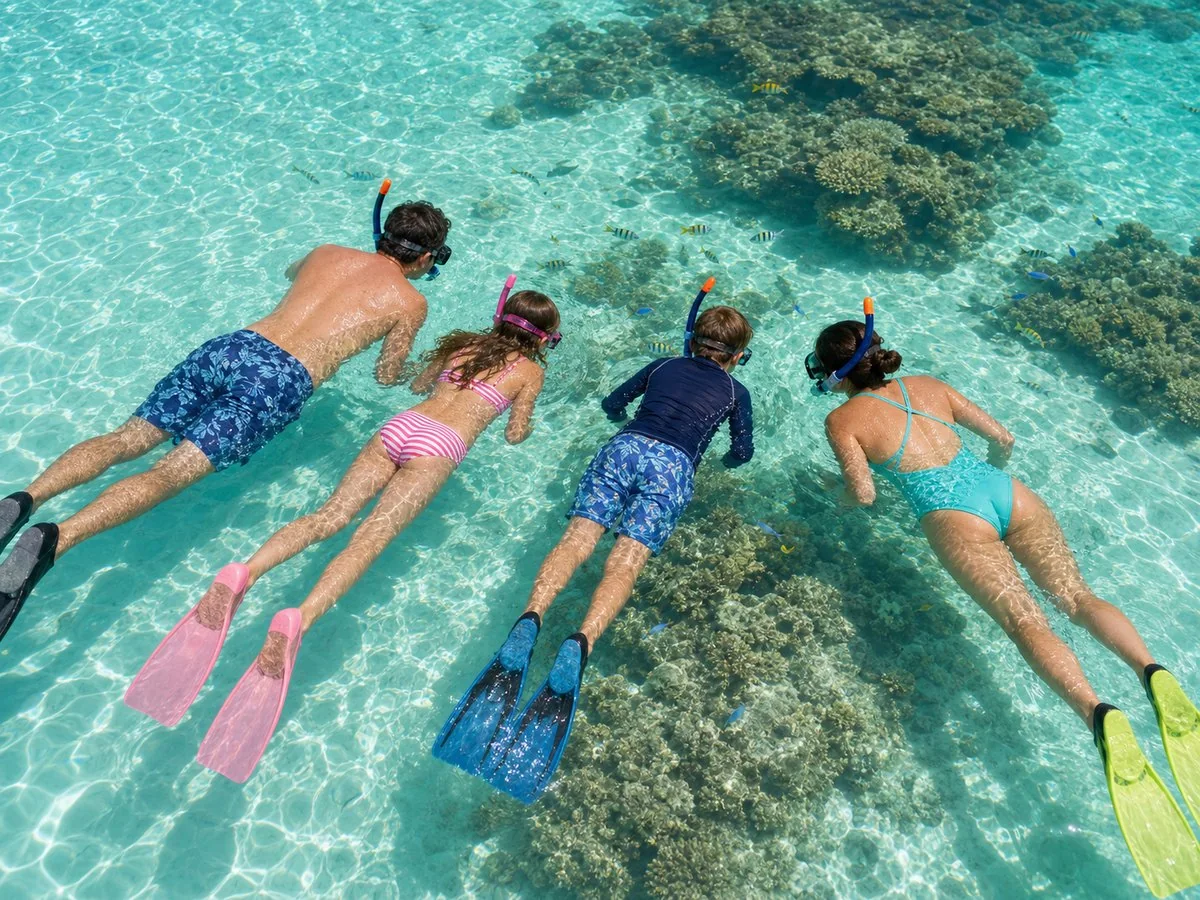 Maldives family snorkeling lagoon A family snorkeling in a shallow maldives lagoon