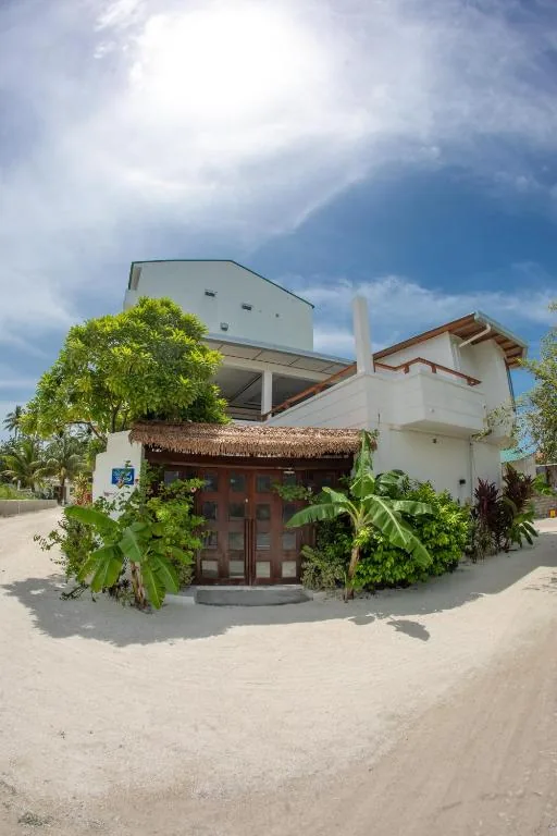 Building on the beach with trees and plants at Maldivine, Dhiffushi, Maldives