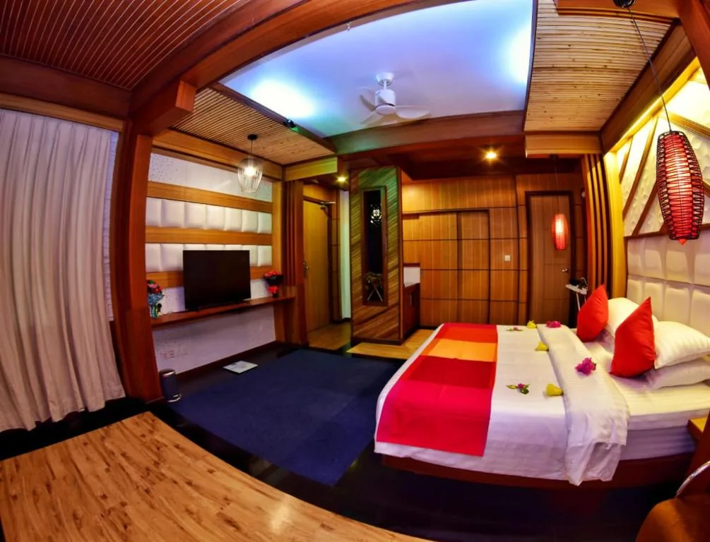 Bedroom with a large bed in a room at Millennium, Fuvahmulah, Maldives