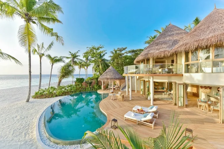 Thatched two-bedroom beach residence with a curved infinity pool and deck on the sand at The Nautilus Maldives, Baa Atoll
