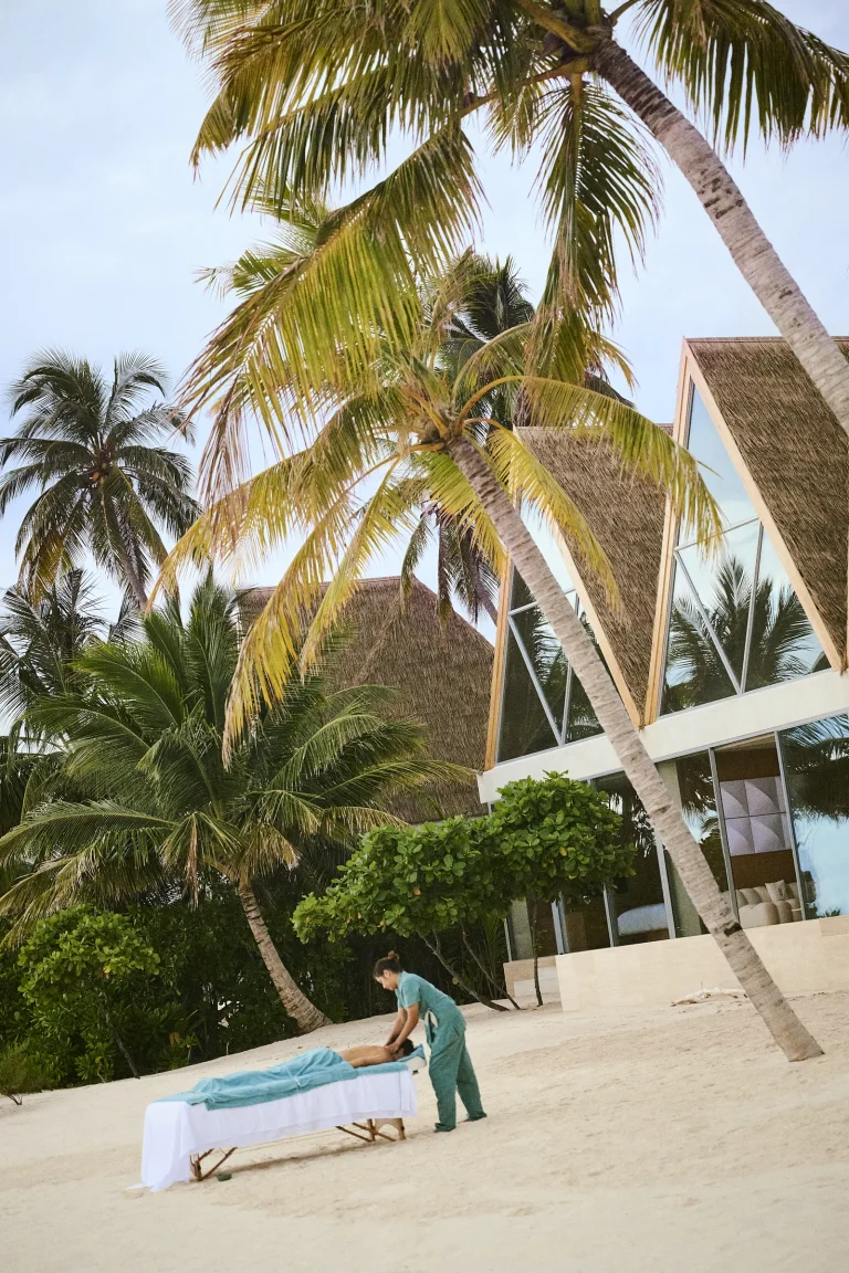 Nilaa Coral Island, Gaafu Dhaalu Atoll, Maldives: spa treatment bed set up on the beach under palms