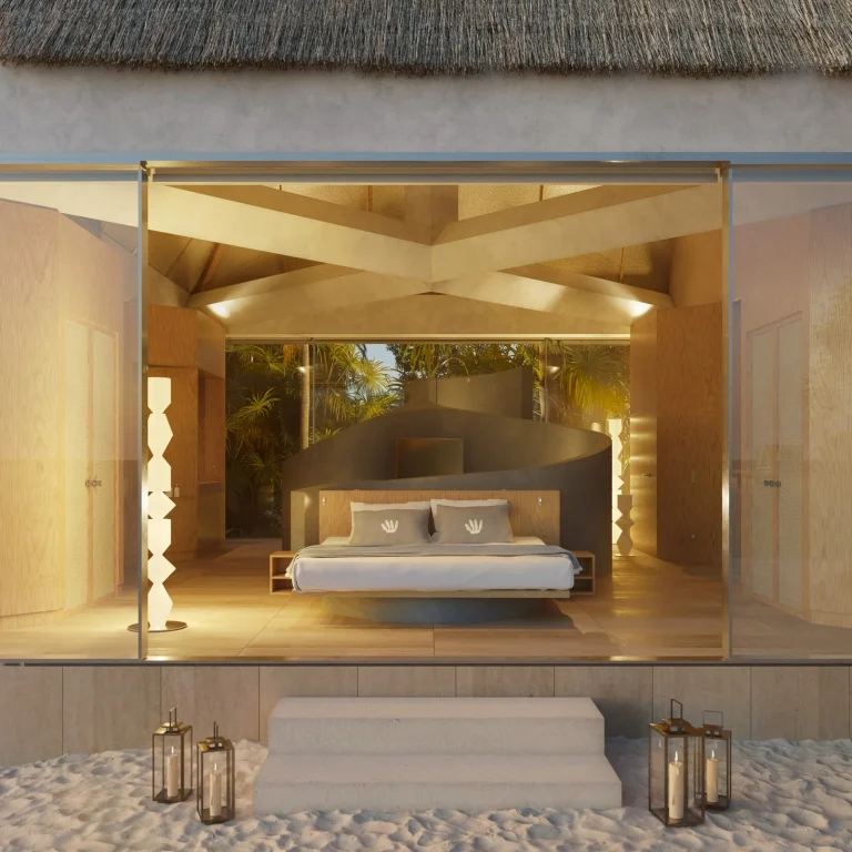Glass-fronted bedroom pavilion lit at dusk beside lanterns on the sand, Nilaa Coral Island, Gaafu Dhaalu Atoll, Maldives