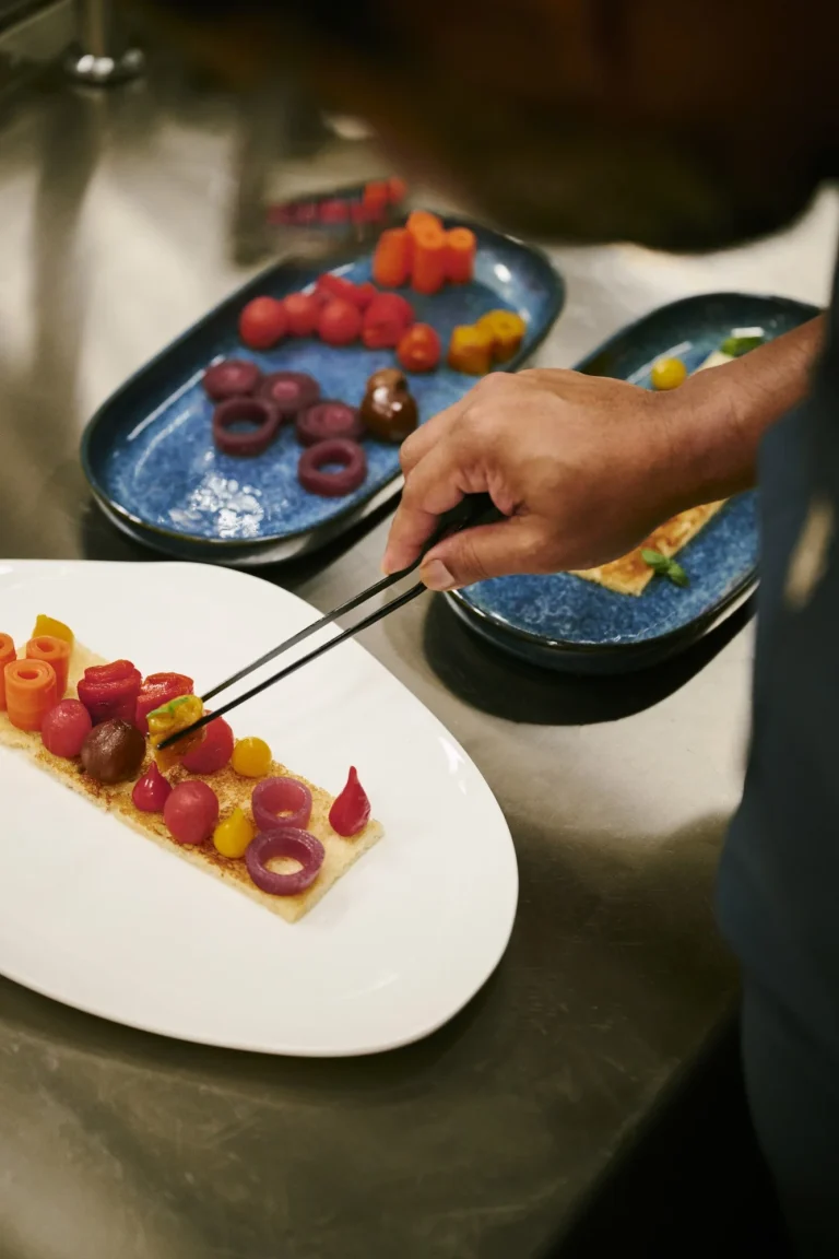 Chef plating colourful dishes with tweezers, Nilaa Coral Island, Maldives