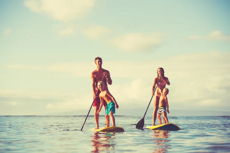 Nilaa Coral Island, Gaafu Dhaalu Atoll, Maldives: couple paddleboarding on the lagoon