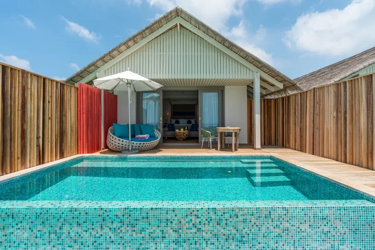 Front of an overwater Lagoon Pool Villa with a long blue private pool and timber deck above the lagoon at Cora Cora Maldives, Raa Atoll
