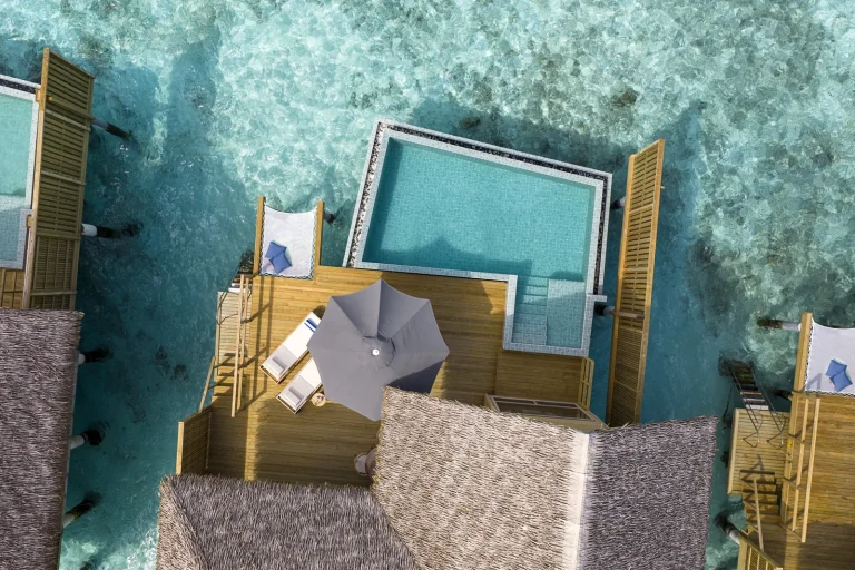 Top-down drone view of a Deluxe Ocean Pool Villa private pool and deck over clear reef water at Kandolhu Maldives, North Ari Atoll