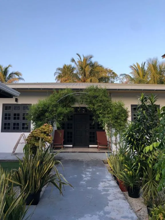 House with two chairs in front of it at Thresher Shark Inn, Fuvahmulah, Maldives
