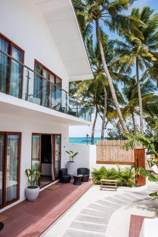 External view of a house with palm trees at Veli Vilaa, Dhiffushi, Maldives