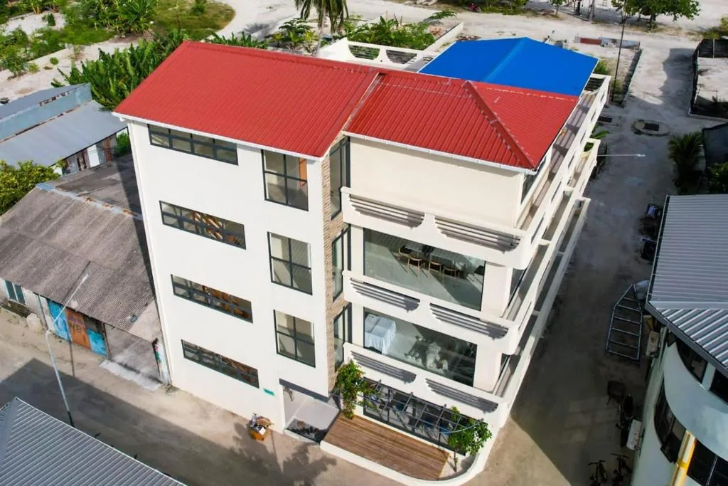 Overhead view of a white building with a red roof at Wish Guesthouse, Huraa, Maldives